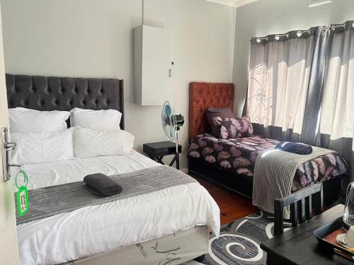 Ένα ή περισσότερα κρεβάτια σε δωμάτιο στο HavenTrust Guest house
