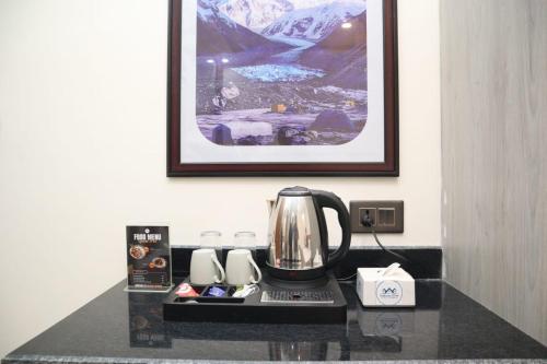 a coffee maker on a counter in a hotel room at Hotel Pahuna Ghar in Nepālganj