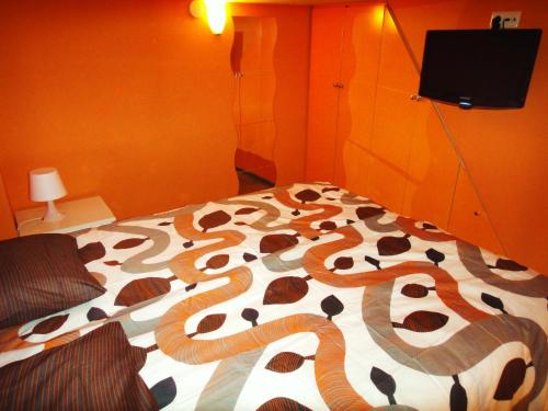 a bedroom with a bed with a snake design on it at Orange Suite Studio in Amsterdam