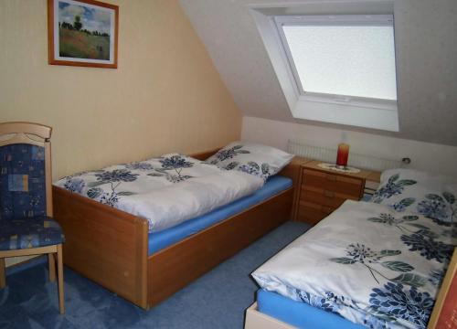 a bedroom with two beds and a window at Gerä Umige Ferienwohnung In Lay Am Moselhang in Koblenz