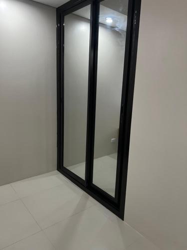 a black framed mirror on a white wall at baseline prestige in Cebu City
