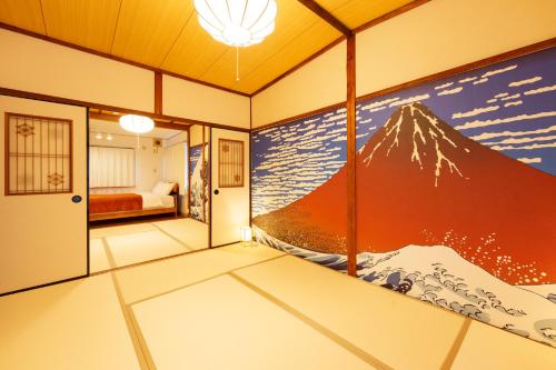 a room with a mountain mural on the wall at 畳庵嵐山 in Kyoto