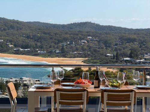 a table with wine glasses and a view of the ocean at Breathtaking views at Vista by the Sea in Copacabana