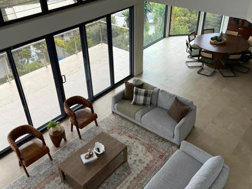 a living room with a couch and a table at Breathtaking views at Vista by the Sea in Copacabana