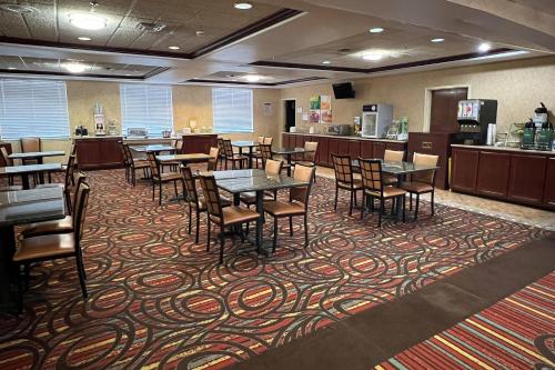 ein Esszimmer mit Tischen und Stühlen auf einem Teppich in der Unterkunft Quality Suites Midland North Loop 250 in Midland