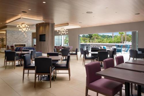 a restaurant with tables and chairs and a patio at Hotel Lela Wilmington, Tapestry Collection By Hilton in Wilmington