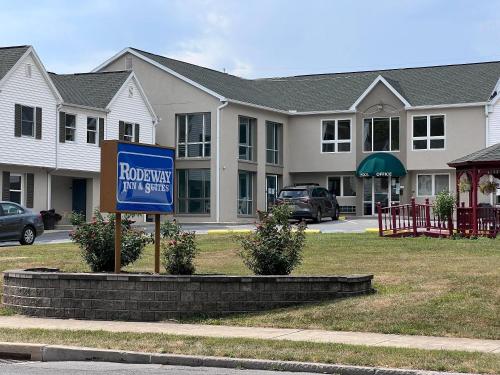 a sign in front of a house with a roxbury at Rodeway Inn & Suites Hershey Chocolate Avenue in Hershey