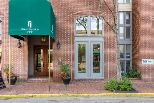 a brick building with a green awning on it at Church Street Inn Historic Charleston, Ascend Collection Hotel in Charleston