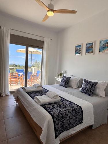 a bedroom with a large bed with a ceiling fan at Villa Paradisio in EFL