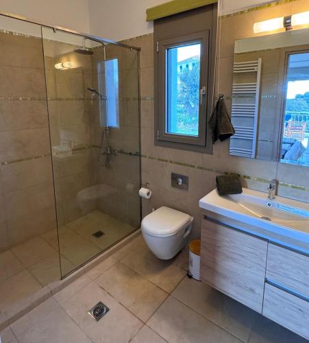 a bathroom with a shower and a toilet and a sink at Villa Paradisio in EFL