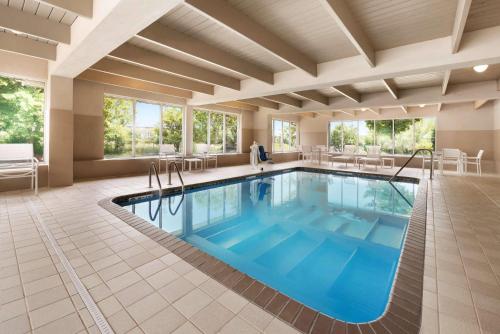 a pool in a hotel room with blue water at Country Inn & Suites by Radisson, Minneapolis West, MN in Plymouth