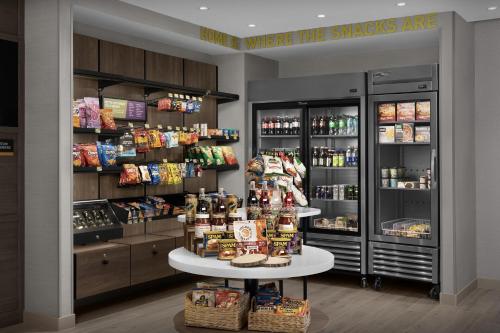 a grocery store with a counter with food and drinks at Home2 Suites By Hilton Ramsey in Ramsey