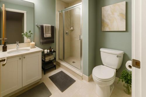 a bathroom with a toilet sink and a shower at Luxury 2-Bedroom Apartment in Coal Harbour with Stunning City Views in Vancouver