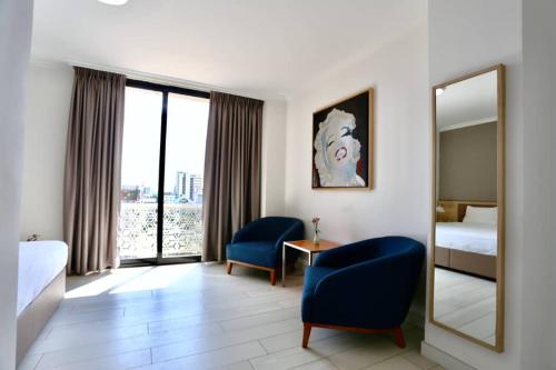 Ένα ή περισσότερα κρεβάτια σε δωμάτιο στο Le Basilic Hotel Apartment & Spa