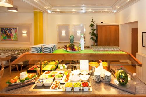 a buffet of food on display in a hotel room at The Domicil Hotel Frankfurt City in Frankfurt/Main
