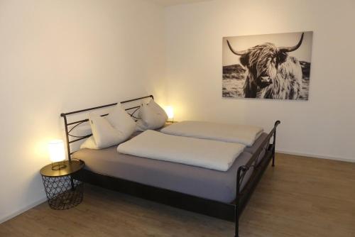 a bedroom with a bed with a picture of a bull at Apartment in Stetten bei Mindelheim in Stetten