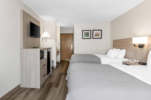 a hotel room with two beds and a television at Quality Inn East Liverpool - Calcutta in East Liverpool
