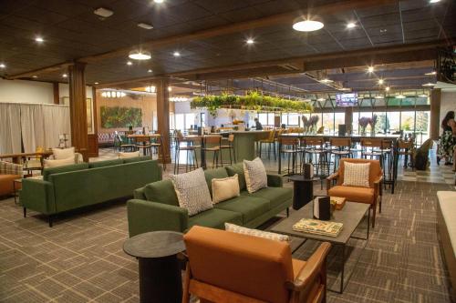 a lobby with couches and tables and a bar at Bay Valley Resort, a Wyndham Hotel in Bay City