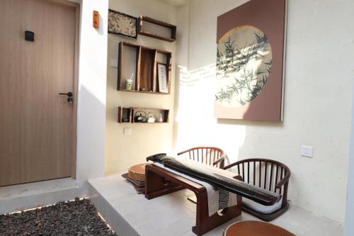 - un salon avec deux chaises et un banc dans l'établissement Suzhou Garden Nook Pingjiang Laneway Hideaway, à Suzhou