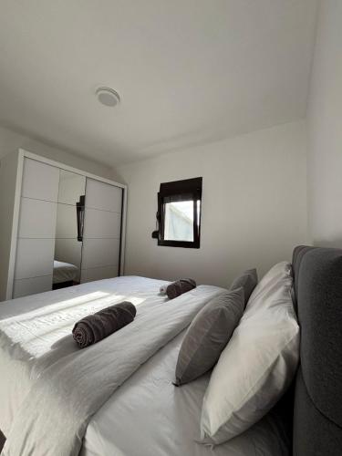 a bedroom with a large bed with two pillows on it at Lakeside View in Kuside