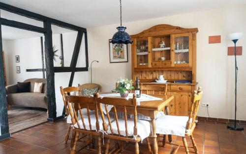 a dining room with a table and chairs at Romantik Ferienhaus 1854 in Elpe