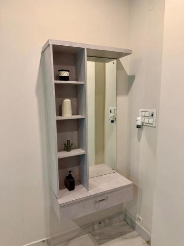 a bathroom with a white cabinet with a mirror at Vididhi By N - 2BHK Neo Stay in Kottapeta