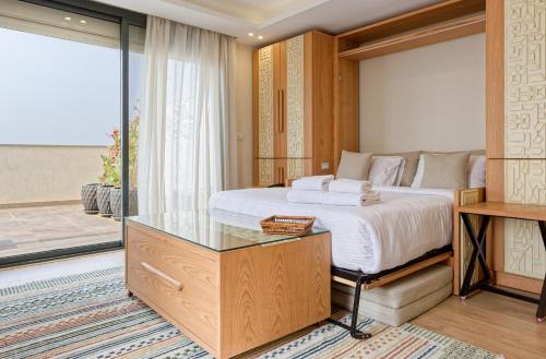 a bedroom with a king sized bed and a glass cabinet at VESTA - New Cairo Residence in New cairo