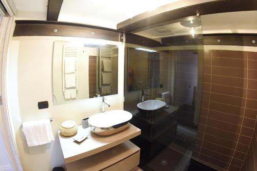 a bathroom with a sink and a mirror and a shower at San Francesco Suite in Poggio Bustone