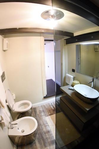 a bathroom with a toilet and a sink at San Francesco Suite in Poggio Bustone