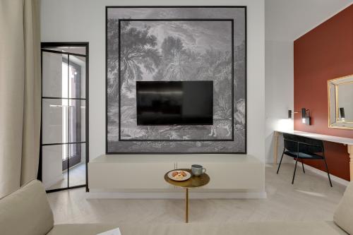 a living room with a tv on a wall at GRANO APARTMENTS Gdańsk Granaria in Gdańsk