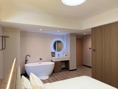 un bagno con vasca, lavandino e specchio di Star Hotel Pattaya a Centro di Pattaya