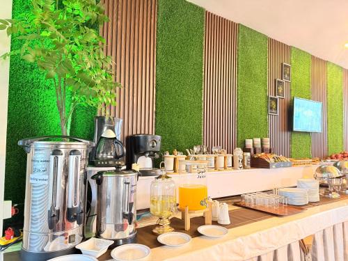 a restaurant with a counter with a coffee maker at Khyber Hotel in Kabul