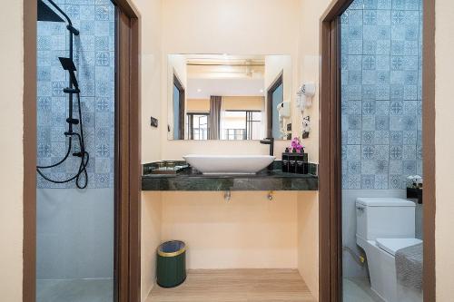 a bathroom with a sink and a toilet at Amaleena Pool Access Suites in Ban Bang Chak