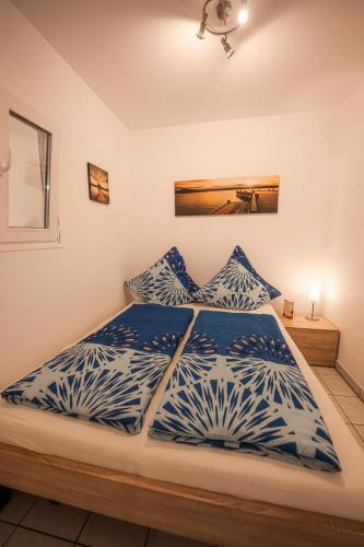a bedroom with a bed with blue and white pillows at Ferienwohnung Keppeln in Piesport