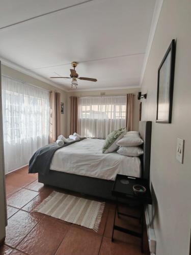 a bedroom with a large bed and a window at Coral Cottage in Hilton