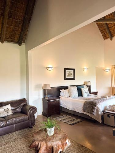 a bedroom with a large bed and a couch at ParkView Safari Lodge in Colchester