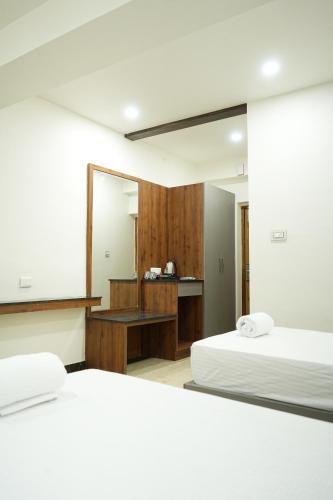 Ένα ή περισσότερα κρεβάτια σε δωμάτιο στο The President Hotel, Tumkur