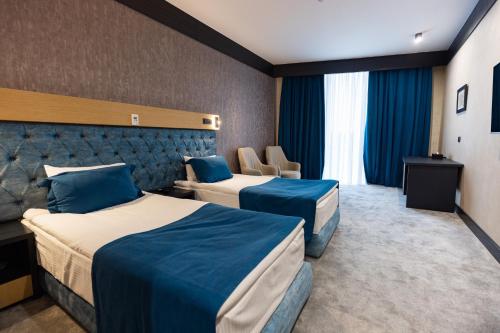 Ένα ή περισσότερα κρεβάτια σε δωμάτιο στο Ganja Sport Palace