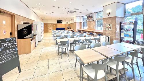 a classroom with tables and chairs in a cafeteria at Toyoko Inn Hakata Nishi-nakasu in Fukuoka