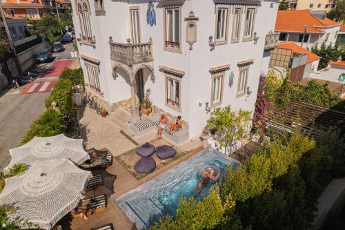 an aerial view of a house with a swimming pool at The Salty Surf & Yoga in Monte Estoril