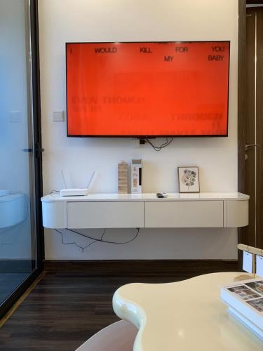 a television hanging on a wall in a room at X-Stay Sweet in An Khê