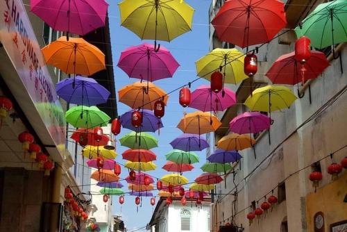 a bunch of colorful umbrellas hanging from a building at IPOH The Majestic Ipoh Town View Fully Air-Con Homestay in Ipoh