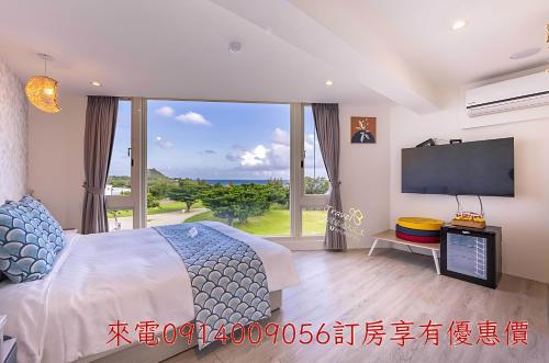 Postel nebo postele na pokoji v ubytování 墾丁卿卿文旅