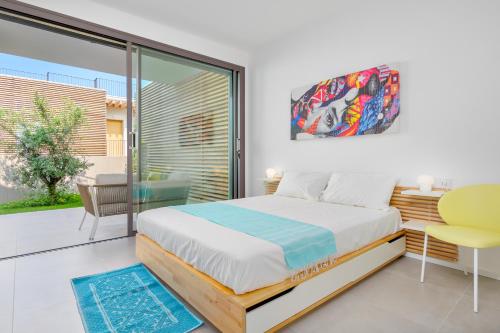 een slaapkamer met een bed en een glazen schuifdeur bij Villa Mathis - by And service in Casa Tamponi