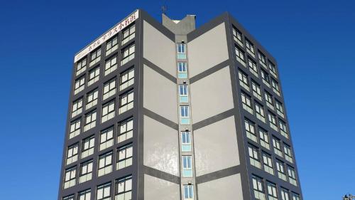 a tall building with a bat on top of it at ホテルテラス小名浜 in Iwaki