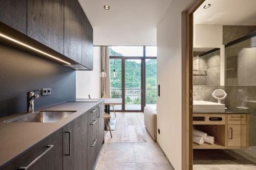 a kitchen with wooden cabinets and a sink at Hotel Ansitz Gamp in Chiusa