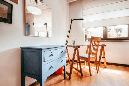a blue dresser and a chair in a room at Casa da Rampa By Gt House in Sintra