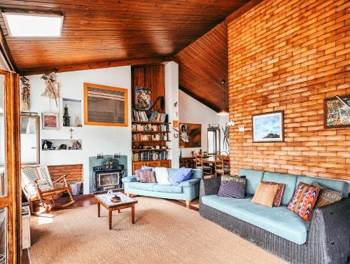 a living room with two couches and a brick wall at Casa da Rampa By Gt House in Sintra