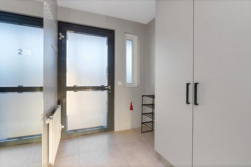 a room with two sliding doors in a building at Bright and Spacious Condo Downtown in Reykjavík