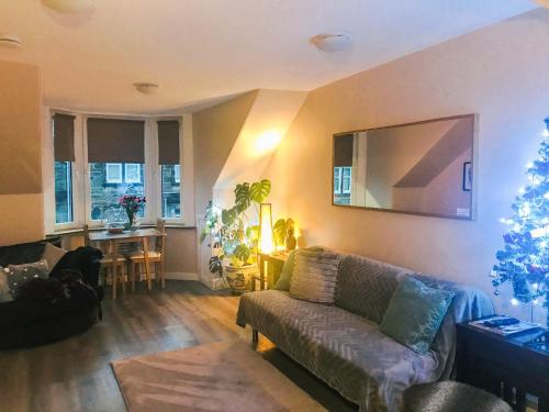 a living room with a couch and a christmas tree at The Wee Pad - Uk42918 in Dunfermline